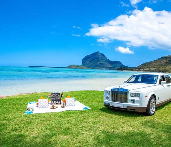 Rolls Royce with picnic hamper on the beach